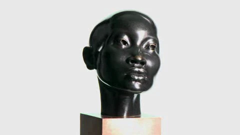 Dark bronze portrait bust with carefully modeled eyes and lips